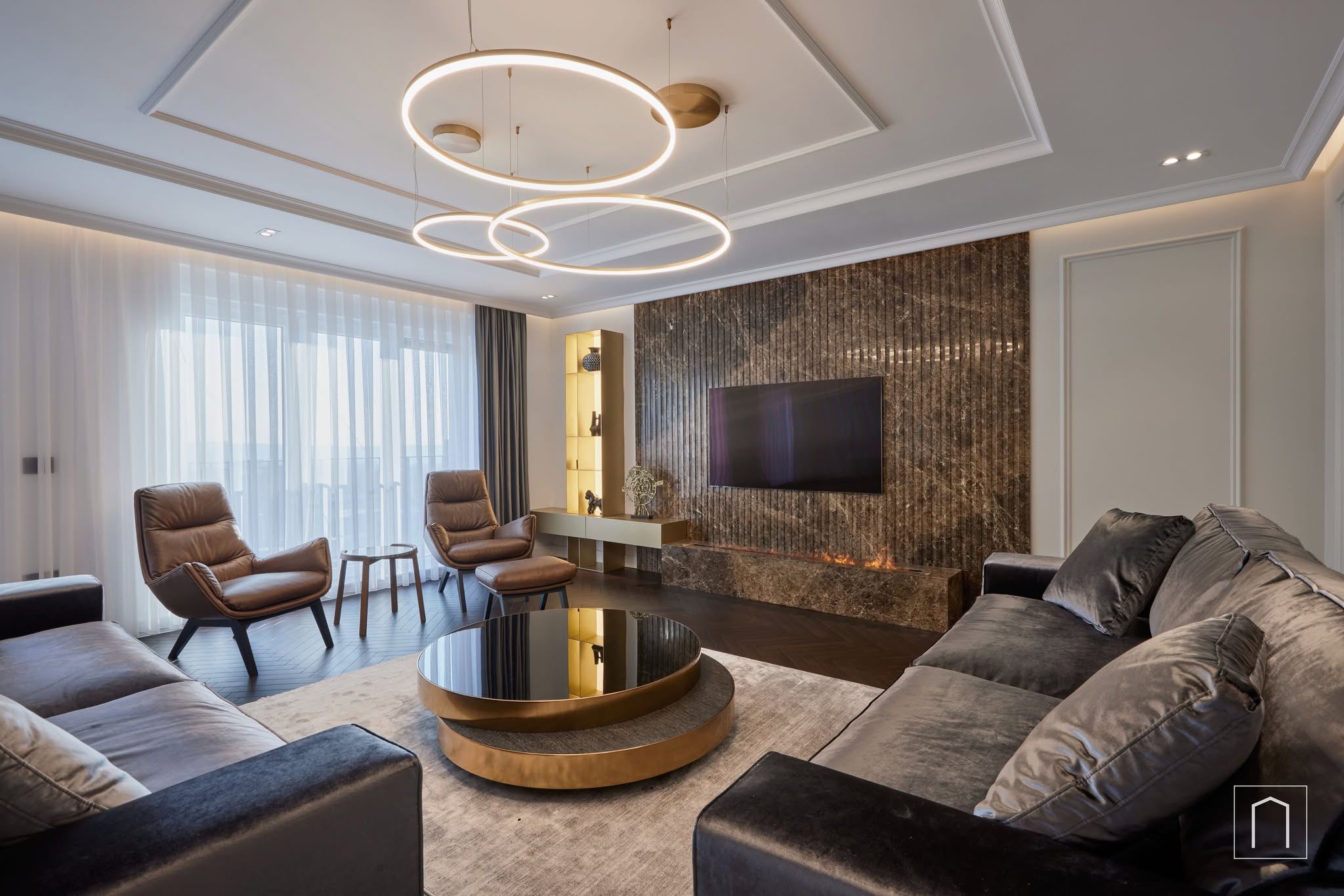 AV Penthouse living space, with a curved sofa, sculptural lighting and layered natural materials
